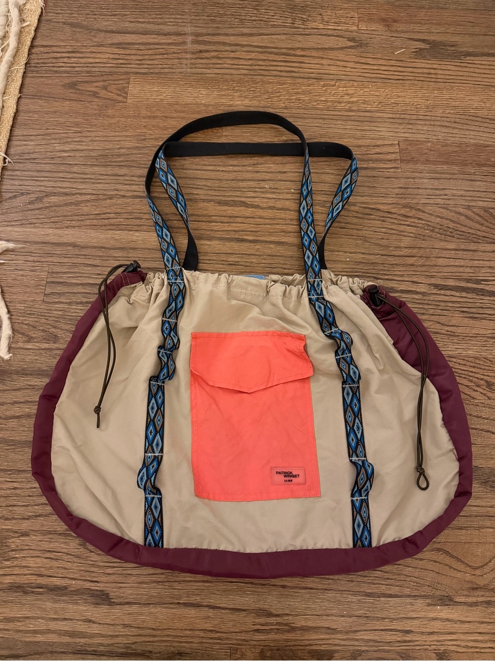 Beige and Coral Drawstring Tote with Patterned Blue Straps